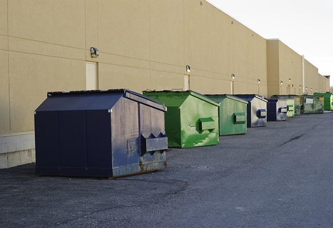 a pile of demolition waste sits beside a dumpster in a parking lot in Delaware Water Gap